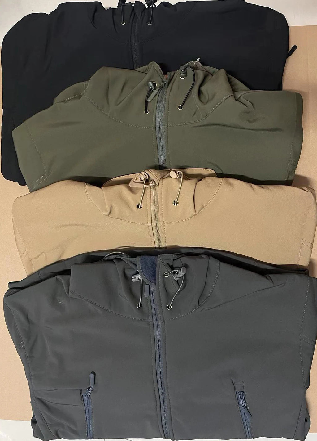 VALEWARD Bastion Softshell Jacket folded, showing the Tactical Black, Ranger Green, Field Sand and Gunmetal Grey colourways.