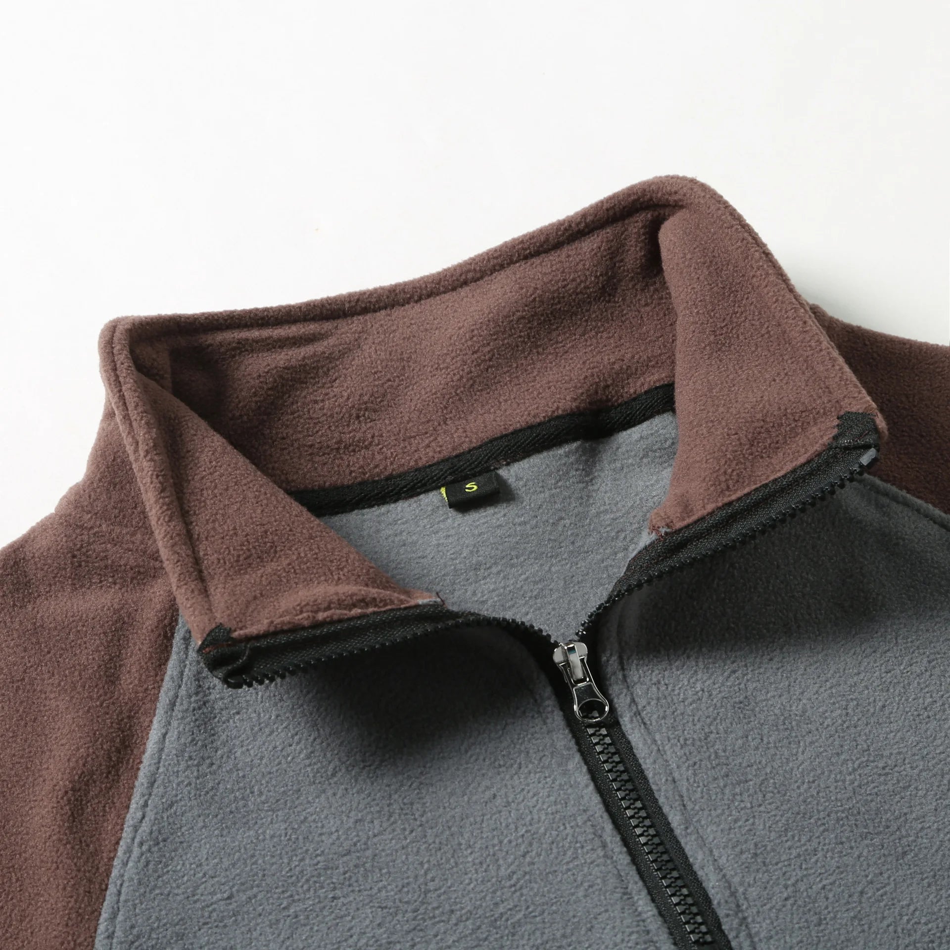 Detail view of the Outrider's stand collar and half-zip placket in Night Navy.